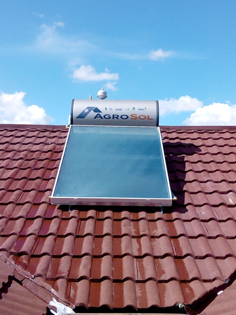 a solar water heater on the roof of a house