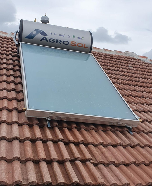 a solar water heater on the roof of a house
